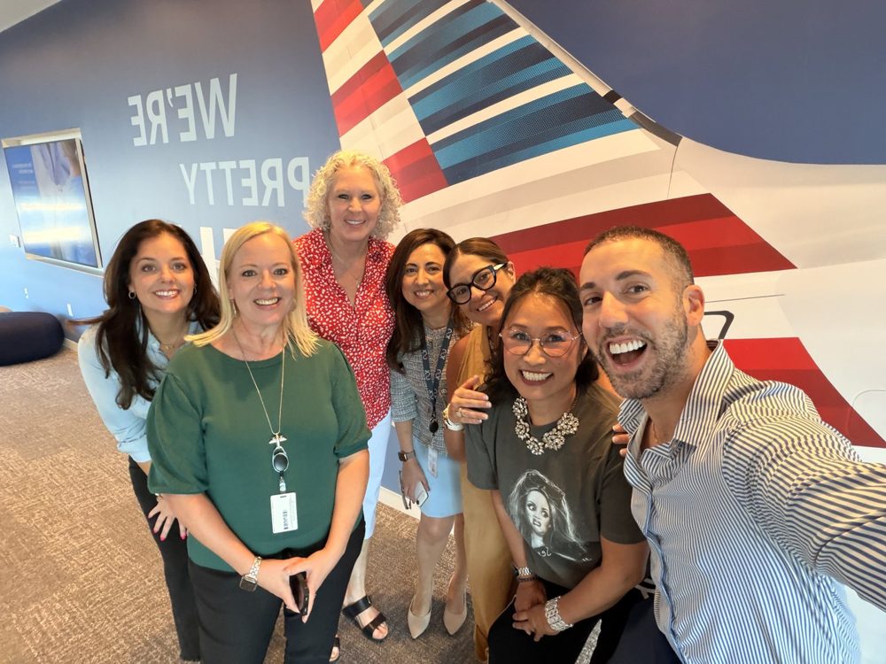 A group selfie of community members at a travel industry event